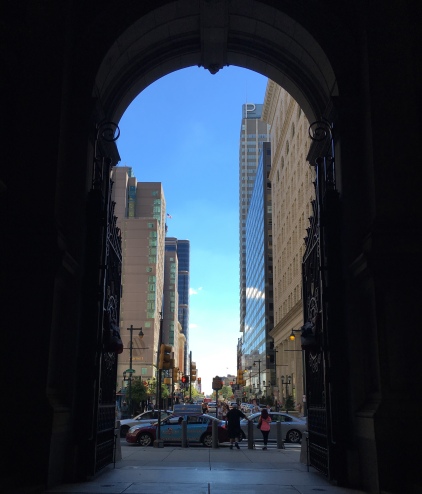 looking out from under the arches of city hall